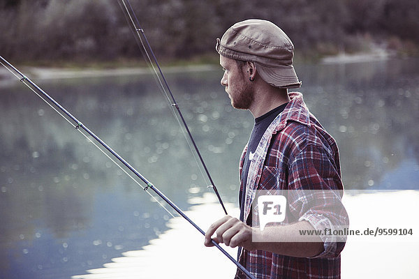 Young fisherman fishing in lake  Premosello  Verbania  Piemonte  Italy
