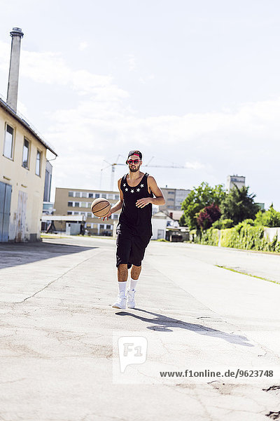 Young man running with basketball