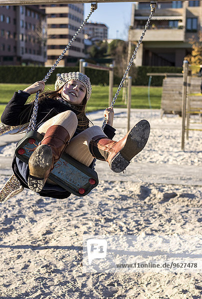 Girl wearing having fun on a swing