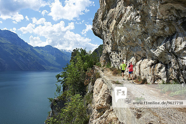 Italy  Trentino  couple running at Lake Garda