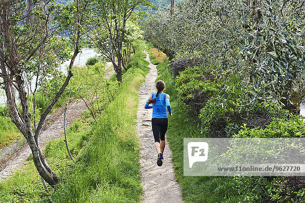Italy  Trentino  woman running near Lake Garda