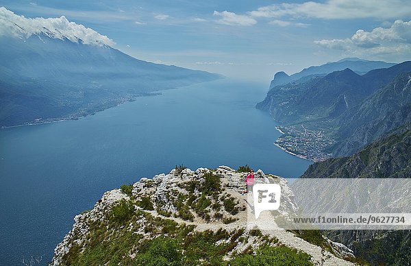 Italy  Trentino  woman running on mountain peak at Lake Garda