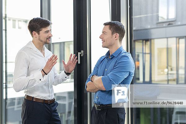 Two businessmen communicating in an office