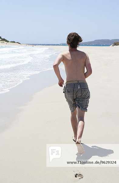 Greece  Elafonisos  young man running on sandy beach
