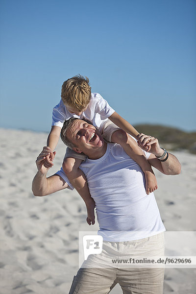 Father and son playing at beach
