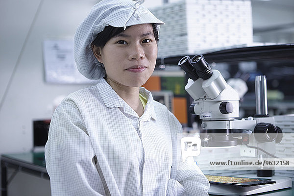 Portrait of worker in factory that specialises in creating functional circuits on flexible surfaces