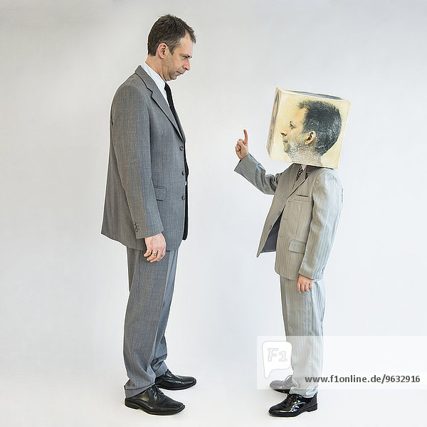 Boy wearing mask arguing with businessman
