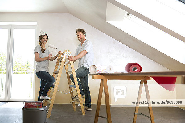 Man woman couple renovating home decorating