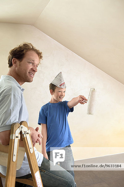 Father young boy painting decorating room happy