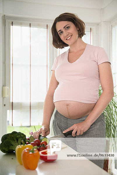 Pregnant woman preparing lunch salad healthy food