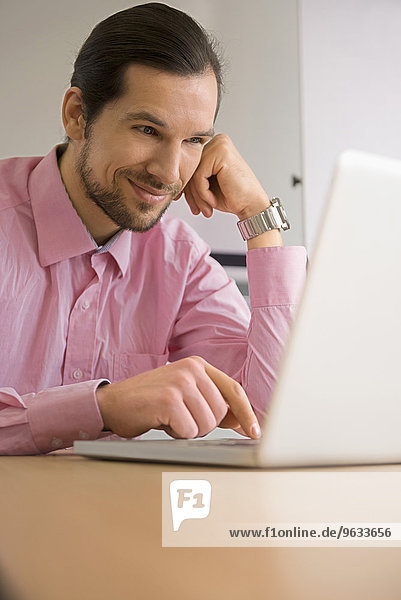 Office computer man working smiling typing laptop