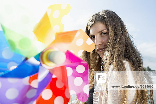 Close up portrait young woman toy windmill