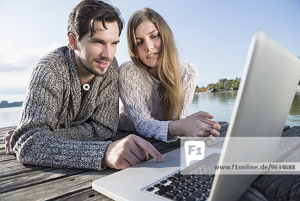 Couple working outdoors laptop computer