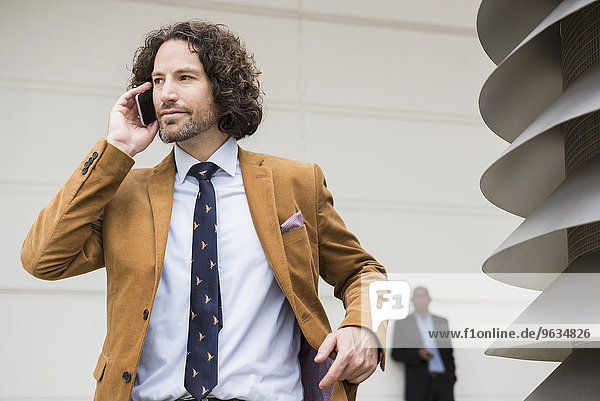 Businessman suit brown cell phone talking