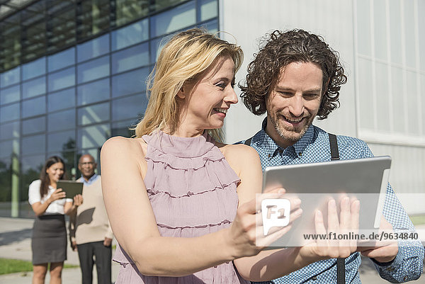 People meeting modern building tablet computer