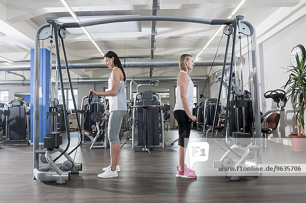 Two young women fitness studio sport practising