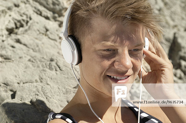 Close-up portrait male teenager headphones music