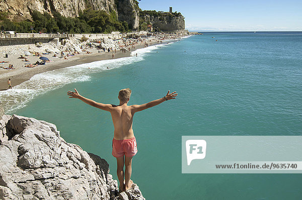 Teenager boy cliff holiday ocean waiting adventure