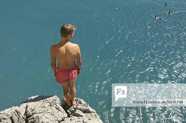 Waiting up high teenager cliff diving holiday