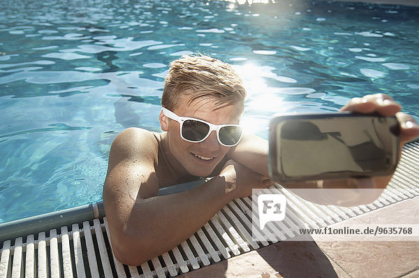 Mobile phone teenager swimming pool selfie holiday