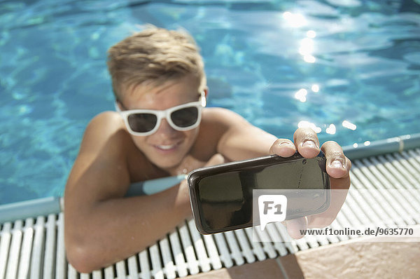 Close-up teenager boy swimming pool self-portrait