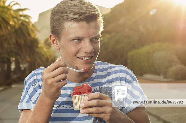 Teenager sunset eating ice cream summer