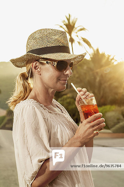 Portrait chic mature blond woman holiday cocktail