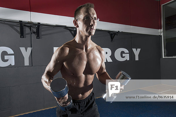 Muscular man fitness weight training posing