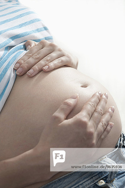 Close up woman hands on stomach pregnant