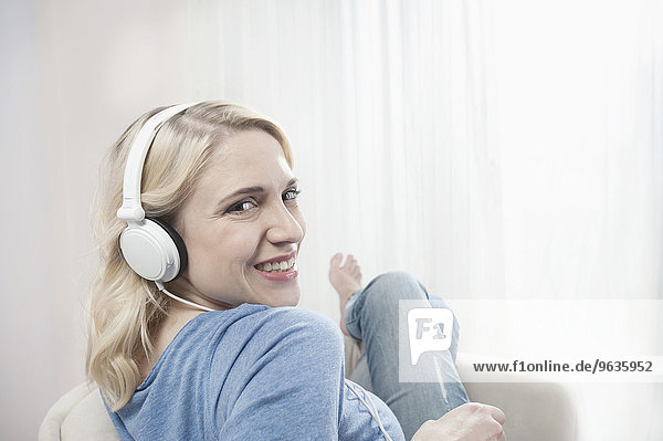 Young woman chair listening music headphones