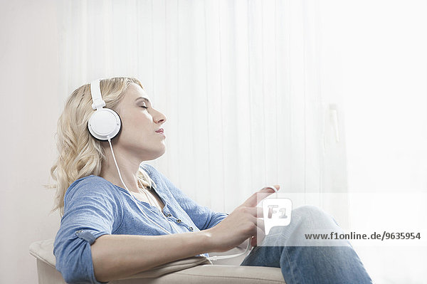 Woman eyes closed listening music headphones