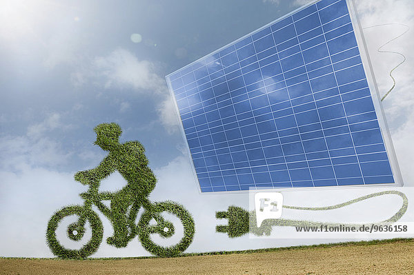 Eco friendly green bicycle just unplugged from a green energy source solar panels