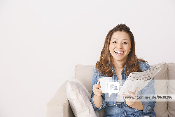 Smiling Japanese Woman On The Sofa