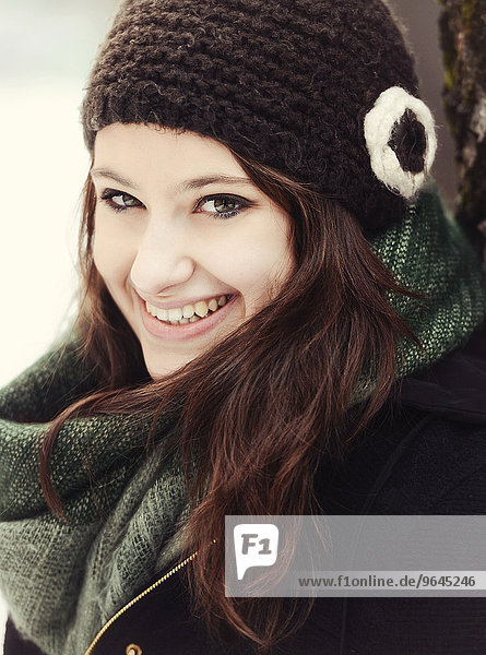 Smiling young woman wearing hat and scarf in winter  portrait