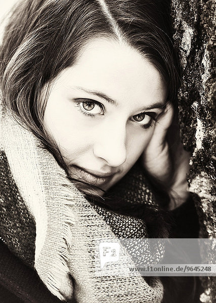 Thoughtful young woman wearing a scarf  portrait