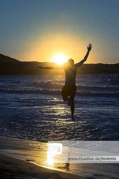 Young man  silhouette  jumping on the beach at sunset  sunset by the sea  Haute-Corse  Corsica  France  Europe