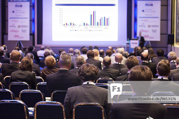 Delegates watching a business presentation during a conference