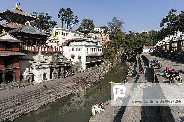 Left Pashupathinath Temple  in front Ghat for royal cremations  river Bagmati  Pashupatinath  Kathmandu  UNESCO World Heritage Site  Nepal  Asia