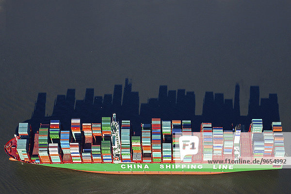 Stacked container casting long shadows  China Shipping Line container ship on the river Elbe  Hamburg  Germany  Europe
