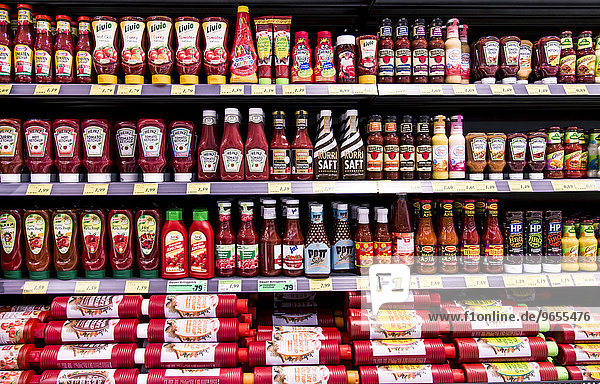 Shelf with various ketchups and sauces  supermarket  Germany  Europe