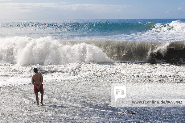 Man standing in front of a giant wave  La Palma  Canary Islands  Spain  Europe