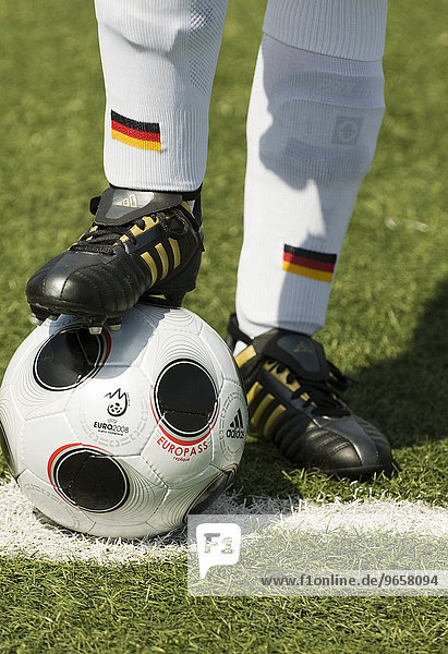 The foot of a German national football player standing on a replica of the EUROPASS  the official match ball of the Euro 2008