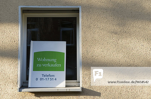 Sign in a window promoting sale of condominiums in a multifamily residence  Duesseldorf  North Rhine-Westphalia  Germany  Europe