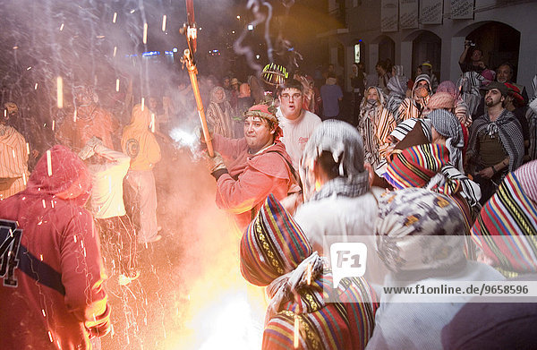 During the Correfoc or Fire Run  hooded Fire Devils run through the streets of Spanish towns brandishing fireworks  Altea  Costa Blanca  Spain  Europe