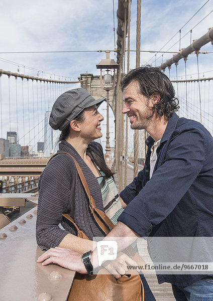 Happy couple on Brooklyn Bridge