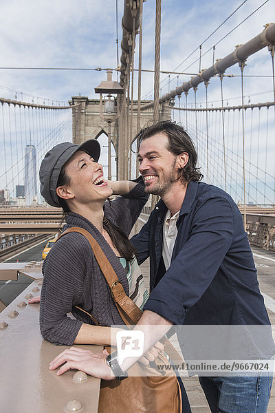 Happy couple flirting on Brooklyn Bridge
