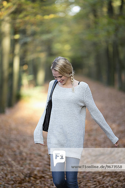 Portrait of smiling woman in autumn forest