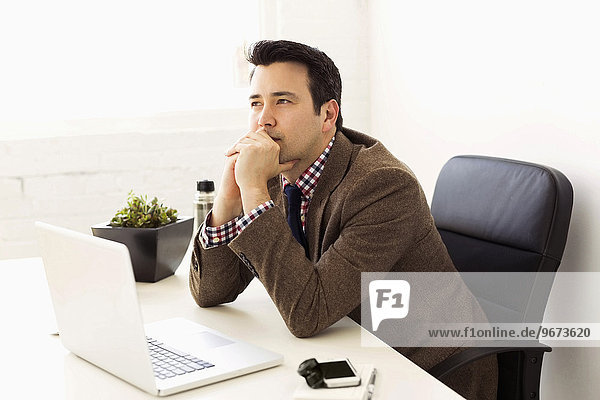 Businessman sitting in office and thinking