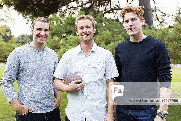 Portrait of young men with football