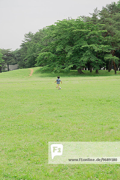 Japanese kid playing in a park